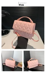 Detailed view of pink quilted handbag with round handle and adjustable shoulder strap