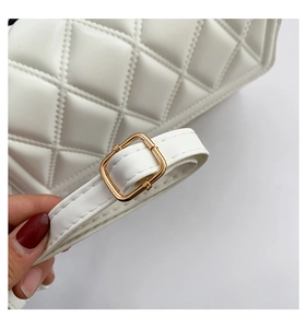 Detailed close-up of white quilted PU leather texture and gold metal strap buckle