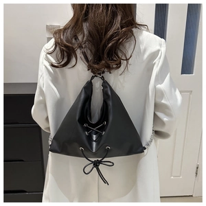 Versatile black leather triangle tote bag with drawstring lace-up detail and silver chain