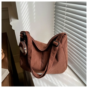 Detailed texture of brown corduroy dumpling bag with matching small round coin purse