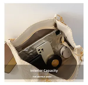 Interior view of spacious woven straw tote bag showing compartments and daily essentials