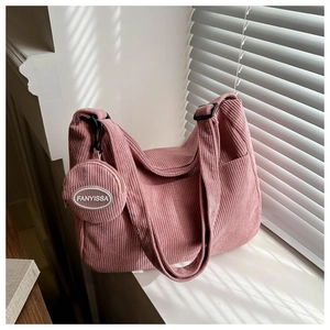 Detailed macro view of pink corduroy tote bag with round FANYISSA coin purse pendant