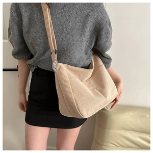 Beige corduroy crossbody bag featuring a textured finish and a cute cloud charm detail