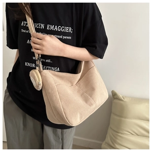 Detail of apricot corduroy tote bag with detachable coin purse on shoulder strap