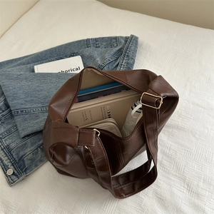 Minimalist large capacity dark brown PU leather tote bag shown with daily essentials