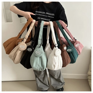 Close-up of corduroy tote bags in multiple colors with matching round coin purses