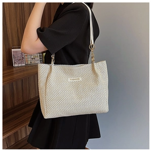 Handwoven straw tote bag with chain strap and fashion tag for spring outfits