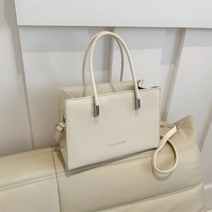 Fashion beige textured leather tote bag with round handles and shoulder strap