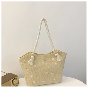 Detailed straw tote bag with white flower embroidery, thick rope handles and fringe knots