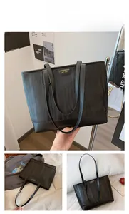 Detail of black tote bag featuring unique wavy pleat texture and brand metal logo