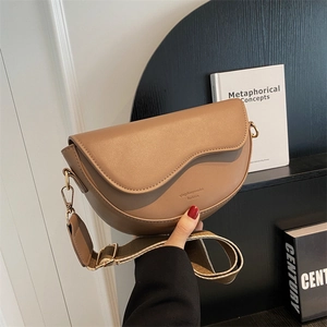 Brown matte PU leather saddle bag with wide canvas strap and gold hardware