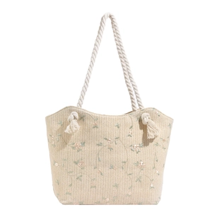 Beige straw tote bag with floral embroidery and white cotton rope handles for summer