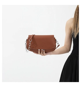 Detail of brown leather saddle bag with silver chain and Fashion & Bags embossed logo