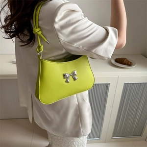 Neon yellow bow shoulder bag with knotted strap and silver bow detail for women
