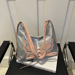 Y2K silver shoulder bag with large pink butterfly appliqué and ribbon lace-up detail