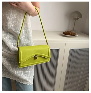 Lime green leather crossbody bag with silver buckle and adjustable shoulder strap