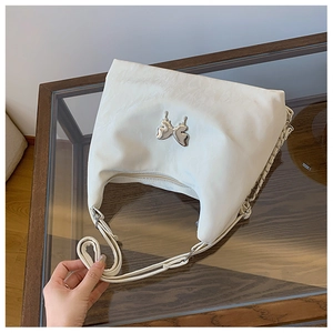 Detail of white crescent shoulder bag with silver butterfly buckle and metal chain strap