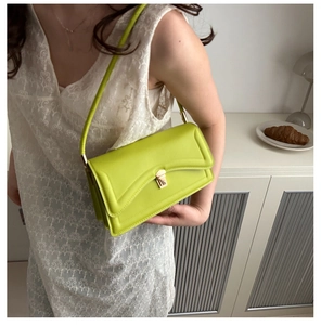 Lime green rectangular leather shoulder bag with quilted stitching and gold lock