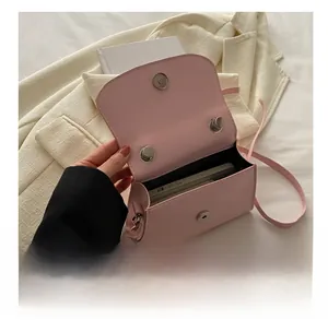 Interior view showing the storage capacity of this pink crossbody bag with a smartphone