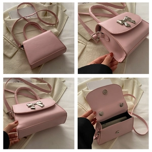 Detail views of pink PU mini square bag with silver metal bow and detachable strap