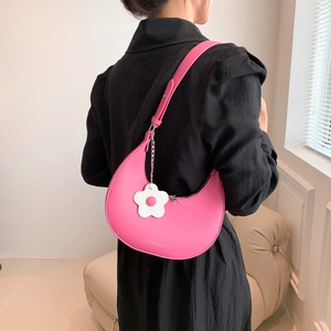 Hot pink crescent moon shoulder bag with floral charm and adjustable strap for women