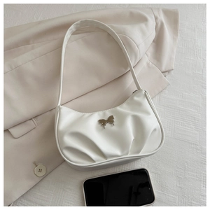 Detail of off-white hobo bag with pleated texture and silver butterfly buckle