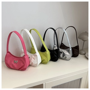 Detailed display of crescent bags in six vibrant colors with butterfly metal accessories