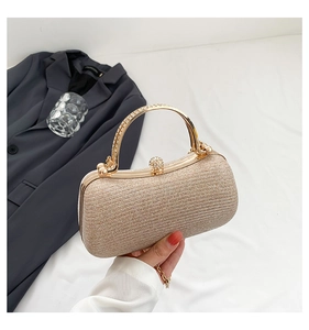 Detailed champagne gold clutch with rhinestone-encrusted ring handle and diamond clasp