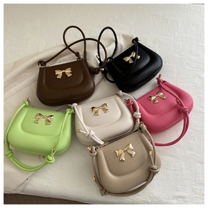 Detailed display of mini saddle bags in six colors with gold bow metal accents
