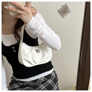 White underarm bag with silver butterfly and cloud pleats shown on a model