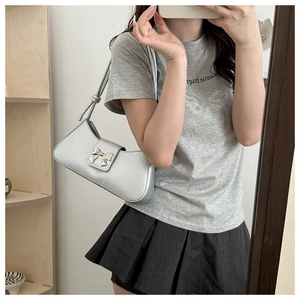 Silver baguette bag with a bow detail shown in a stylish mirror selfie for daily look