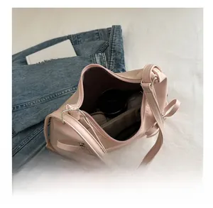 Internal view of a pink bucket tote bag showing large capacity and bow detail