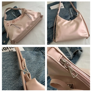 Detail view of pink bow shoulder bag showing zipper craftsmanship and soft PU leather texture