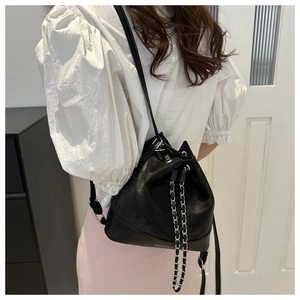 Detail of black drawstring bucket bag with silver chain and Fashion & Bags text on bottom
