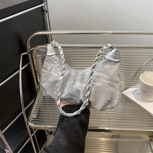 Silver metallic pleated shoulder bag with woven strap and modern ruched texture