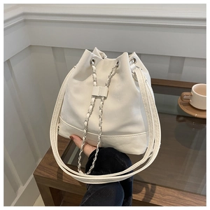 Detail of white pleated bucket bag with silver chain drawstring and Fashion Bags logo