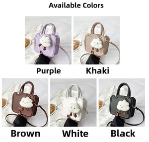 Detail view of five colors of mini square cross-body bags with cloud plush charms