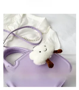 Detail of lavender leather crossbody bag with a cute white cloud plush pendant accessory