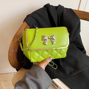Lime green quilted crossbody bag with silver bow buckle and metal chain strap