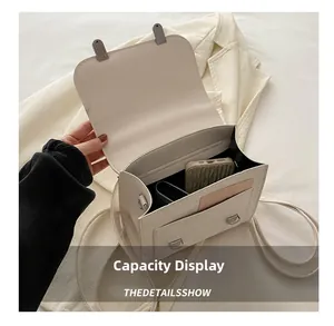 Detailed interior view of beige leather crossbody bag showing card slots and phone pocket