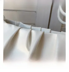 Macro shot of pleated cream PU leather detail and texture on the fashion shoulder bag