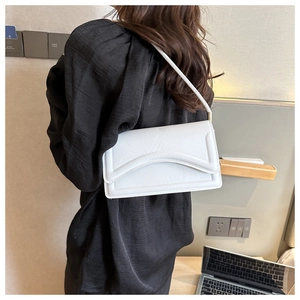 Detailed back view of a white rectangular shoulder bag with elegant curved flap design
