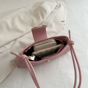 Pink minimalist shoulder bag showing interior space with phone and long wallet