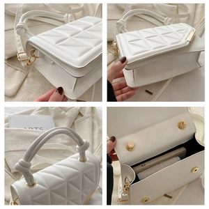 Detail view of white quilted crossbody bag with knot handle and gold hardware