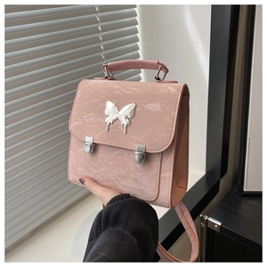 Detailed view of pink marble texture leather backpack with a silver butterfly buckle