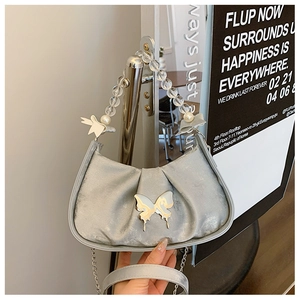 Detailed view of silver satin hobo bag with crystal bead handle and metallic butterfly