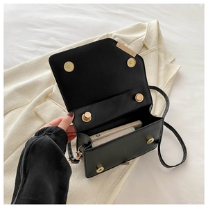 Detail view of the black leather crossbody bag interior showing smartphone storage capacity