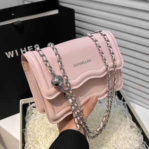 Sac bandoulière rose avec rabat ondulé et décoration élégante de chaîne en argent