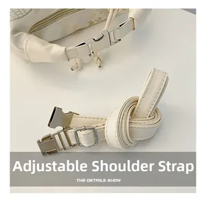 Close-up of adjustable beige PU leather shoulder strap with silver metal buckle detail