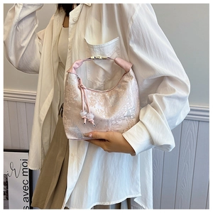 Close-up of pink toile de jouy handbag with jacquard landscape and silver buckle